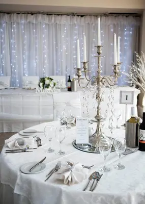 a table with a white table cloth with candles and wine glasses at Avonbridge Hotel in Hamilton