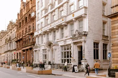 a large white building with a clock on it at Native Glasgow in Glasgow