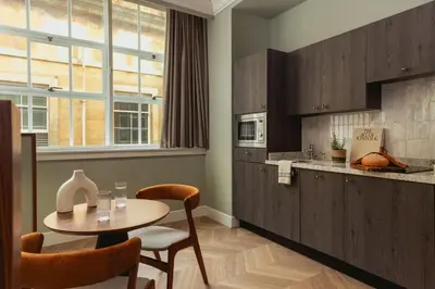 a kitchen with a table and a table and chairs at Native Glasgow in Glasgow