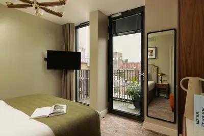 a hotel room with a bed and a balcony at Native Glasgow in Glasgow