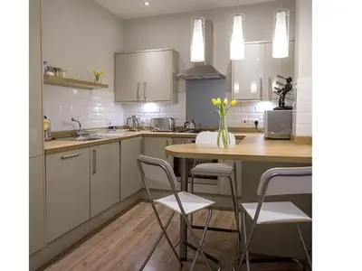a kitchen with a table and chairs and a counter at The Lane Apartment in Edinburgh