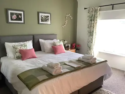 a bedroom with a bed with towels on it at The Garden Flat in Crieff