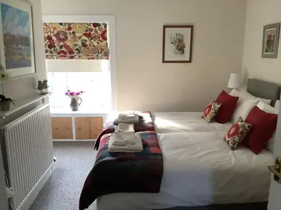 a bedroom with a bed with towels on it at The Garden Flat in Crieff