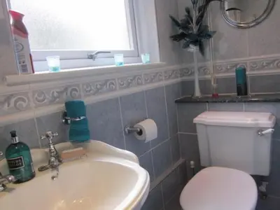 a bathroom with a white toilet and a sink at Three Bridges Bed & Breakfast in Rosyth
