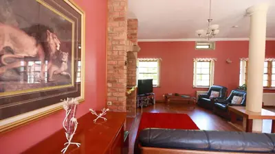 a living room with a couch and a painting on the wall at Coachouse in Balloch