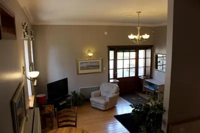 a living room with a chair and a television at Stables Lodge in Balloch