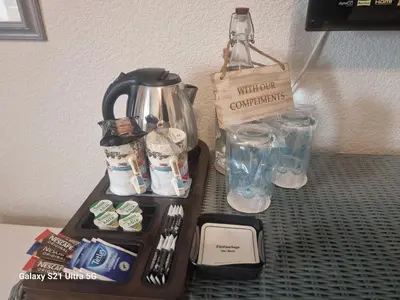 a tray with a coffee pot and glasses on a table at St Leonards Guest House in Largs