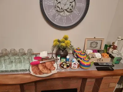 a table with bread and a clock on the wall at St Leonards Guest House in Largs