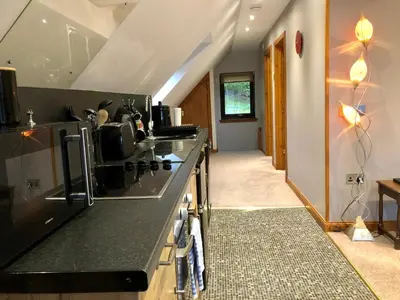 a kitchen with a stove and a counter top at Hunters Lodge Apartments in Ballachulish
