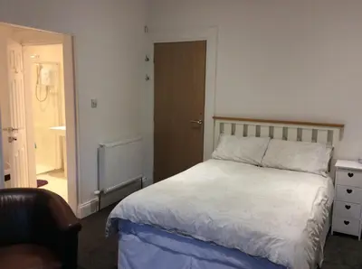 a bedroom with a bed and a door to a hallway at West Highland Way Rooms ED30002F in Milngavie