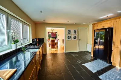 a kitchen with a black refrigerator and a counter top at Chapelhill in Helensburgh