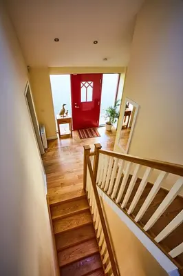 a staircase with a red door in a house at Chapelhill in Helensburgh