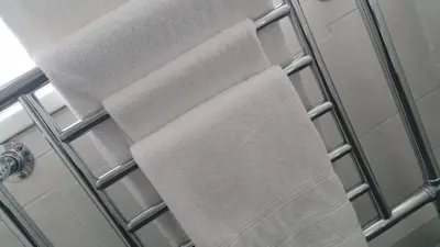 a towel rack with two towels on it in a shower at The Four Seasons Hotel in Saint Fillans