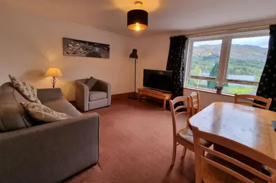 a living room with a couch and a table at The Four Seasons Hotel in Saint Fillans