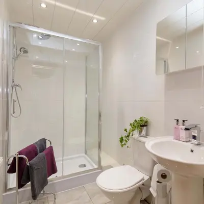 a bathroom with a shower toilet and a sink at Lomond Serviced Apartments- Inglewood in Alloa