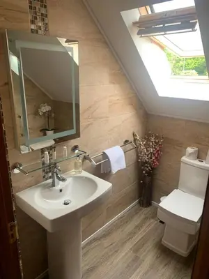 a bathroom with a sink and a toilet with a skylight at Inverasdale in Oban