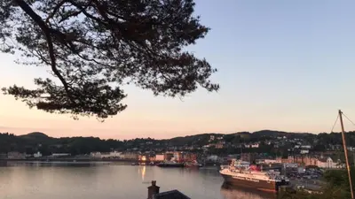 a view of a river with a city and a boat at Inverasdale in Oban