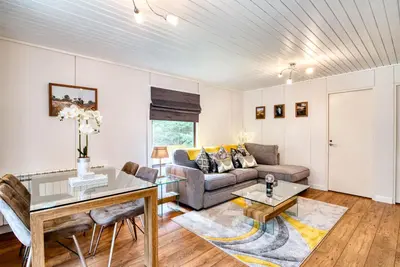 a living room with a couch and a table at Otter with mountain view and enclosed decking in Crianlarich