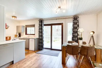 a kitchen and dining room with a table and chairs at Otter with mountain view and enclosed decking in Crianlarich