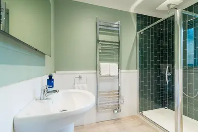 a bathroom with a sink and a shower at Stunning 5 star lodge with loch and mountain views in Crianlarich