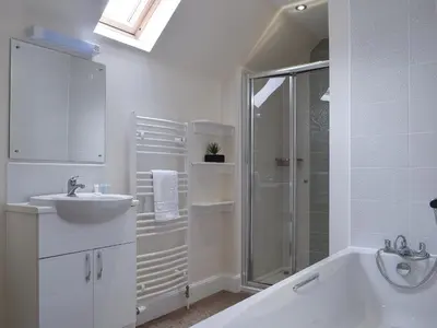 a white bathroom with a sink and a shower at Can Duran in Killin