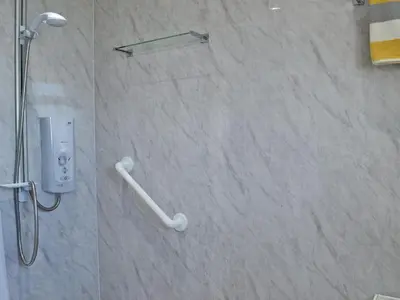 a bathroom with a shower with a controller in it at Ingleside in Ballantrae