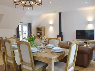a dining room with a table and a couch at Anemone in Kenmore