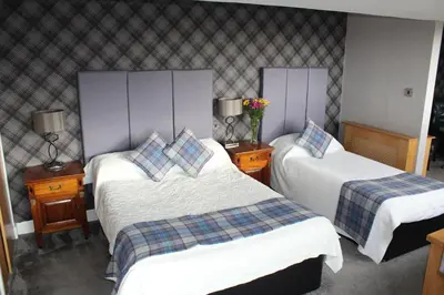 a hotel room with two beds and two lamps at South Beach Hotel in Troon