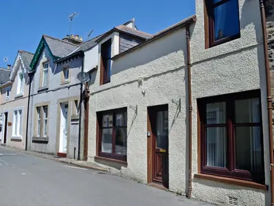 a row of white houses on a street at Summerlea Cottage in Moffat