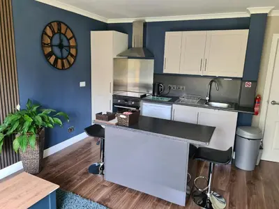 a kitchen with white cabinets and a counter top at Coel Ila in Benderloch