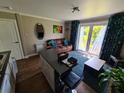 a living room with a couch and a table at Coel Ila in Benderloch