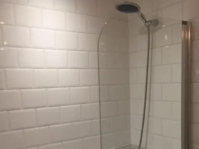 a shower with a shower head in a bathroom at The Clacks Rustic Abode in Tillicoultry