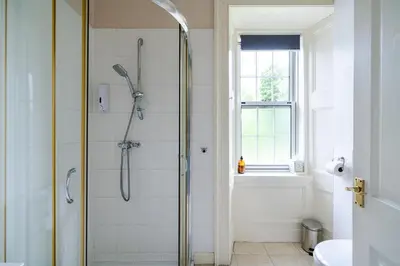 a bathroom with a shower and a sink at Mansewood Country House in Lochearnhead
