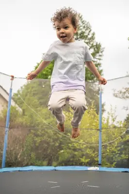 a young child jumping on a trampoline at Forty Winks Loch Lomond in Balloch