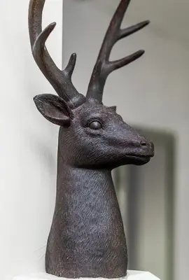 a statue of a deer head on a wall at Balmaha Lodges and Apartments in Balmaha