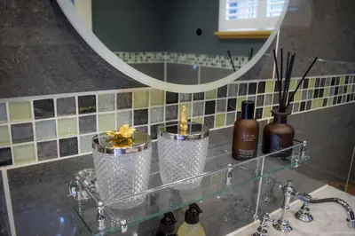 a bathroom sink with two glasses and a mirror at Outlander Glencoe at Creag an-t Sionnaich Glencoe Ballachulish Highlands Near Fort William in Glencoe