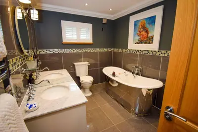 a bathroom with a sink and a tub and a toilet at Outlander Glencoe at Creag an-t Sionnaich Glencoe Ballachulish Highlands Near Fort William in Glencoe