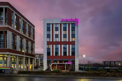 a building with a pink sign on top of it at Moxy Glasgow Merchant City in Glasgow