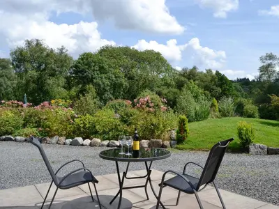 two chairs and a table with a bottle of wine at Wee Cordorcan - Uk5890 in Bargrennan