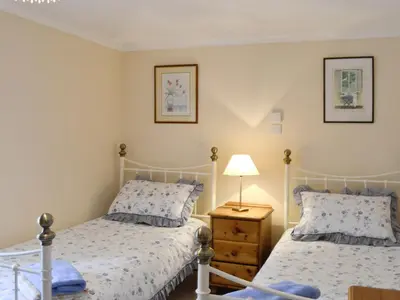 a bedroom with two beds and a lamp on a table at Low Cordorcan - Uk5891 in Bargrennan