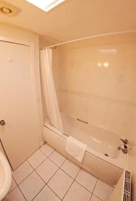 a bathroom with a shower and a tub and a toilet at Abbotsford Hotel in Dumbarton
