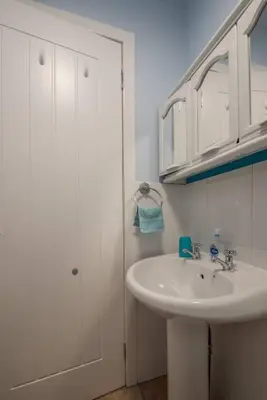 a white bathroom with a sink and a shower at Brucefield Avenue, Dunfermline in Dunfermline