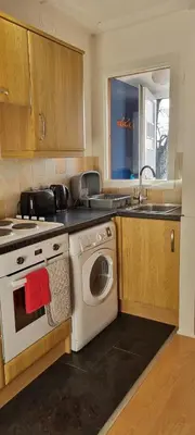 a kitchen with a washing machine and a sink at Brucefield Avenue, Dunfermline in Dunfermline