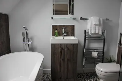a bathroom with a sink and a toilet and a tub at Bay and Bridge near Edinburgh in Dunfermline