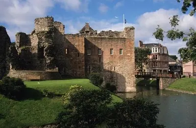 an old castle sitting on the side of a river at Old Fisherman's Cottage in Rothesay