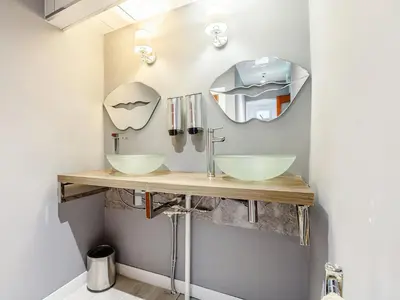 a bathroom with two sinks and a mirror at The Golden Crown in Tarbolton