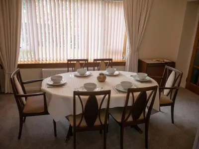a dining room table with chairs and a white table cloth at Abbots Way in Ayr
