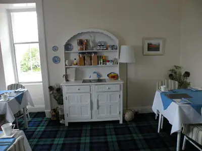 a room with a white cabinet with a sink in it at Thistle House Guest House in Saint Catherines
