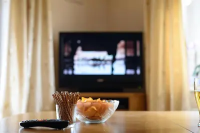 a table with a bowl of food and a television at PREMIER SUITES PLUS Glasgow George Square in Glasgow