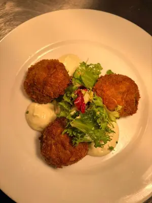 a plate of food with broccoli and sauce on it at The Old Schoolhouse Hotel in Larkhall